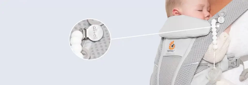 Close-up of Ergobaby Omni Breeze Baby Carrier showing built-in pacifier clip loops for convenience.