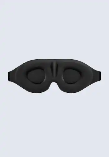 A black sleep face mask designed for travel, helping to block out light and promote restful sleep during flights.