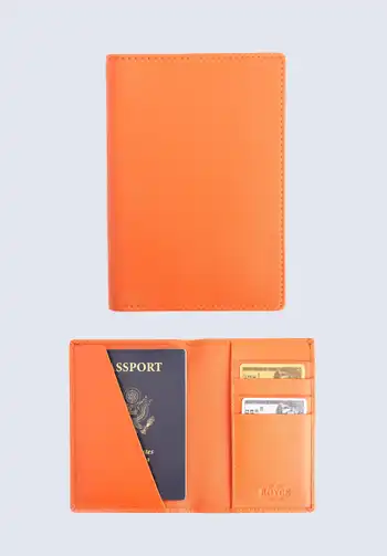 A vibrant orange passport holder from Royce New York, providing a bold and fashionable accessory for travel documents.