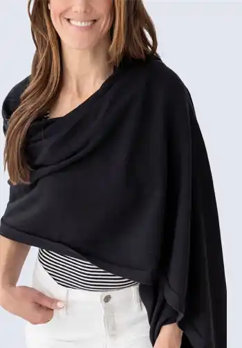 An ultra-soft and stylish black scarf made of plush organic cotton, essential for travel as it can be used as a shawl or blanket for warmth on a plane.

