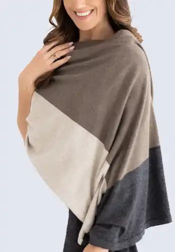 An ultra-soft and stylish neutral color scarf made of plush organic cotton, ideal for use as a shawl or blanket to keep you cozy during your flight.