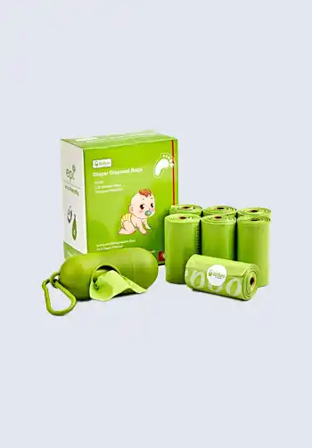 A set of green disposable diaper bags with a dispenser, ideal for containing soiled diapers and keeping your diaper bag organized and odor-free.