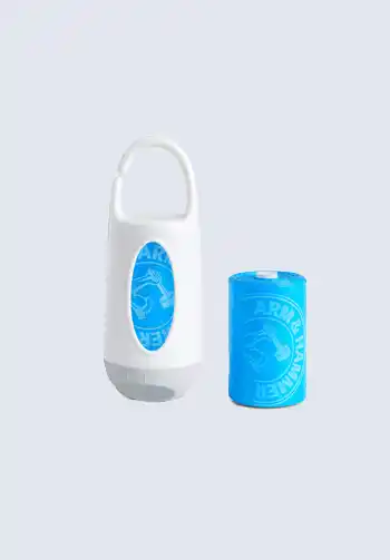 A white dispenser with a roll of blue disposable diaper bags, designed for easy disposal of dirty diapers, great for your diaper bag.