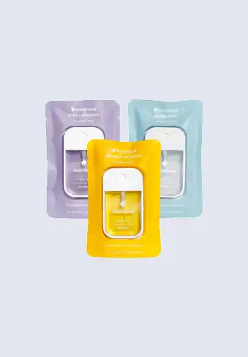 Assorted packs of Touchland hand sanitizers in lavender, aqua, and yellow packaging, ideal for maintaining hand hygiene while out and about, great for your diaper bag.