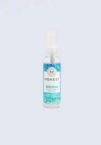 A bottle of Honest Company hand sanitizer spray, offering a quick and easy way to sanitize hands while out and about, essential for your diaper bag.