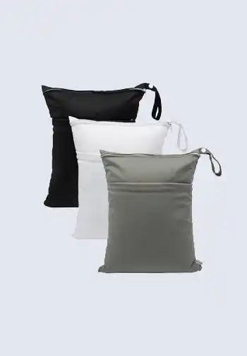 A set of three waterproof wet bags in black, white, and gray, ideal for storing soiled clothes or cloth diapers in your diaper bag.