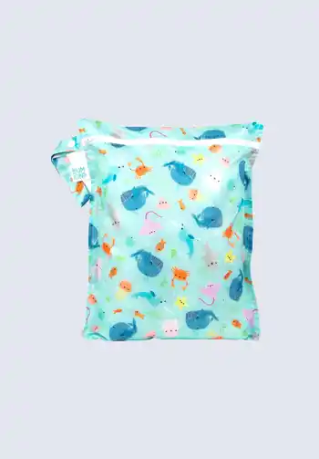 A blue waterproof wet bag with a playful ocean pattern, perfect for containing wet or dirty items in your diaper bag.