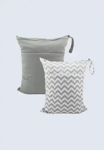 A set of two waterproof wet bags, one in solid gray and one with a chevron pattern, great for organizing dirty items in your diaper bag.