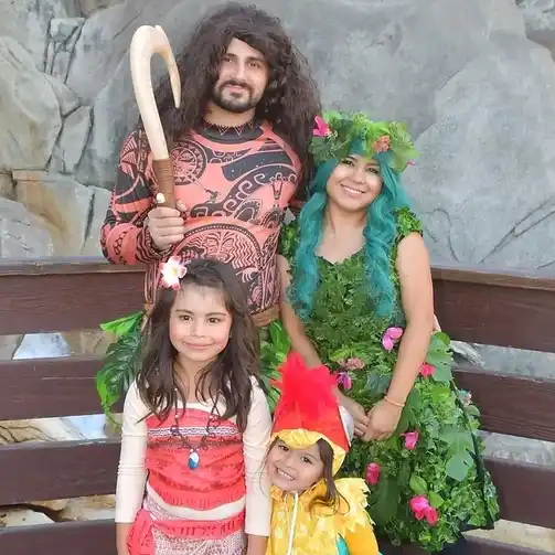 A family dressed as Moana characters, featuring Moana, Maui, Te Fiti, and Hei Hei, perfect for a Moana themed Halloween celebration.