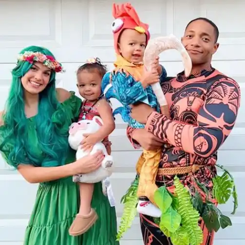 A family showing off their creative Moana costumes for Halloween, with outfits representing Moana, Maui, Te Fiti, and Hei Hei.