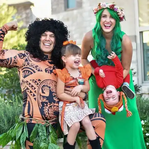  A family dressed up in Moana-themed Halloween costumes, featuring Moana, Maui, Te Fiti, and Hei Hei, creating a magical and adventurous look.