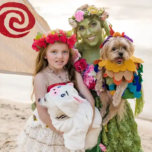 A family in Halloween costumes inspired by Moana characters, including Moana, Maui, Te Fiti, and Hei Hei, Pua, ideal for a Disney-themed Halloween.