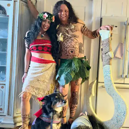 A pair in Halloween costumes as Moana and Maui, perfect for a Disney-themed celebration.