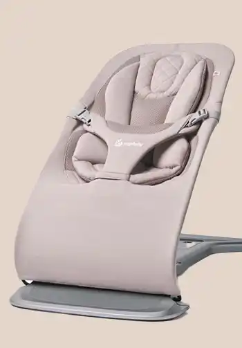 Ergobaby 3-in-1 Evolve Bouncer in a soft blush pink knit fabric, providing a charming and comfortable seating option for your baby.