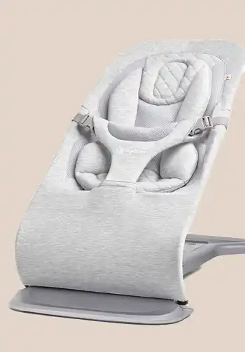 Ergobaby 3-in-1 Evolve Bouncer in a light grey knit fabric, featuring a sleek and versatile design that complements any home decor.