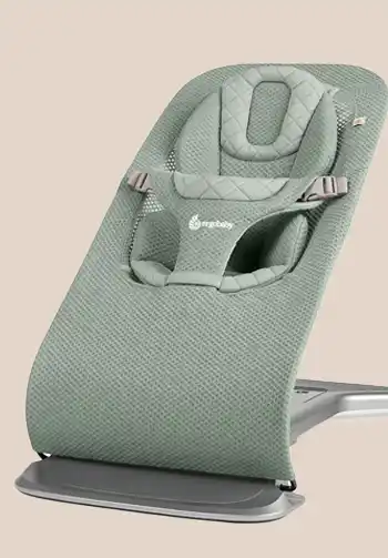 Ergobaby 3-in-1 Evolve Bouncer in a sage green mesh fabric, featuring a breathable and airy design for maximum comfort.