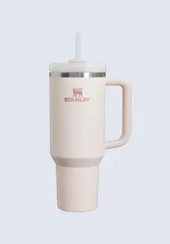 A beige Stanley Quencher tumbler with a straw, ideal for staying hydrated during labor and postpartum, a must-have for a hospital bag for mom.