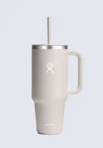 A grey Hydro Flask tumbler with a straw, offering durable and insulated hydration, making it a necessary addition to a hospital bag for delivery list.