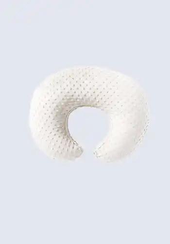 A soft plush nursing pillow, offering cozy support for both mom and baby during breastfeeding. Make sure to include this in your hospital bag checklist.