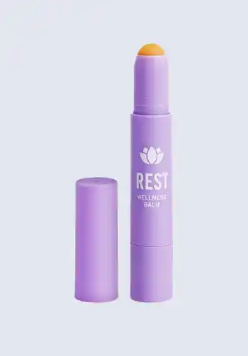 A stick of Rest wellness balm, providing calming effects with natural ingredients, perfect for including in a hospital bag list for birth.