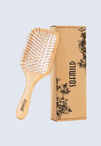 A Sofmild bamboo paddle hair brush, providing gentle detangling and scalp massage, an essential item for a hospital bag list for birth.