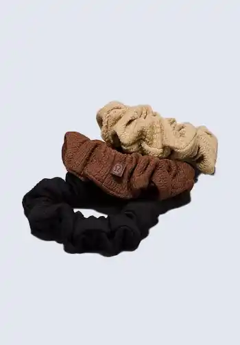  A collection of beige, brown, and black scrunchies, providing comfort and style for new moms, a must-have for a hospital bag for mom.