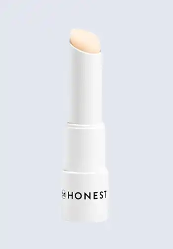 A tube of Honest Beauty lip balm, offering natural, soothing hydration for dry lips, a must-have for a hospital bag for mom.