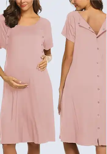 A pregnant woman in a pink, button-down maternity nightgown, perfect for including in a hospital bag list for birth, offering comfort and practicality during labor and delivery.