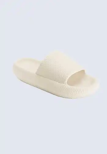 A pair of cream open-toe slippers, ideal for a hospital bag for mom, providing comfort and ease of movement during labor and postpartum.