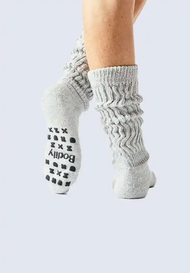 Bodily cozy socks with non-slip grips, providing warmth and comfort during postpartum recovery, a key component of the Bodily postpartum essentials kit.