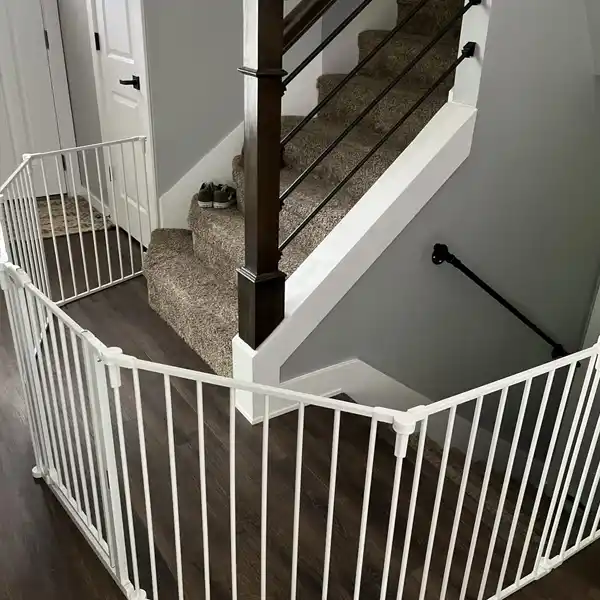 The Regalo Super Wide Baby Gate and Play Yard configured to secure a staircase area, preventing access to the stairs. This setup showcases the gate’s ability to adapt to different home layouts, ensuring staircase safety. Perfect for creating a safe space for your child while maintaining flexibility in your home.