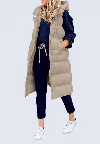 Stay warm and stylish with this long beige puffer vest, a versatile piece for soccer mom attire. Its extended length and cozy design make it perfect for layering over a sweatshirt or hoodie. Ideal for maintaining comfort during outdoor games.