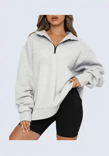 This casual gray zip-up sweatshirt is perfect for soccer moms who value both comfort and style. The zip-up design offers versatility, allowing for easy layering. Match it with black bike shorts for a complete and cozy soccer mom outfit.