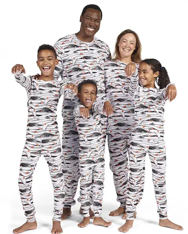 A family of five wearing mummy-themed matching family pajamas, perfect for Halloween celebrations.