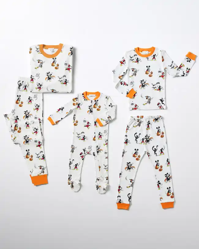 Matching family Halloween pajamas featuring beloved Disney characters like Mickey and Minnie Mouse dressed in Halloween costumes with pumpkins and bats, perfect for adding a touch of Disney magic to your Halloween celebrations.