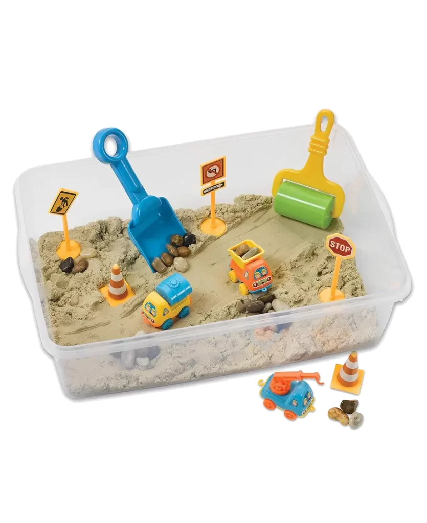 Sand Construction Site Sensory Bin set with sand, toy vehicles, road signs, and tools in a plastic container.