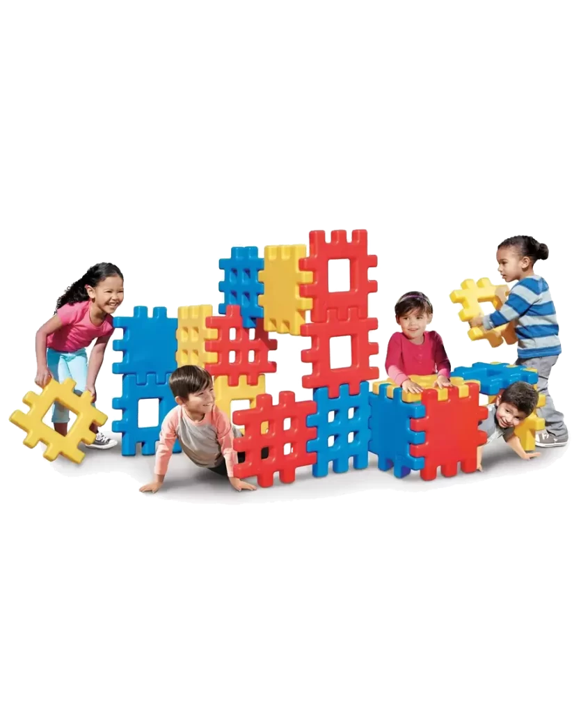 Children playing with the Little Tikes Big Waffle Block Set, building various structures with large, colorful interlocking blocks.