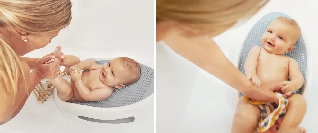 A mother bathing her baby in the Angelcare Bath Support, showing the baby enjoying bath time in the baby bath tub.