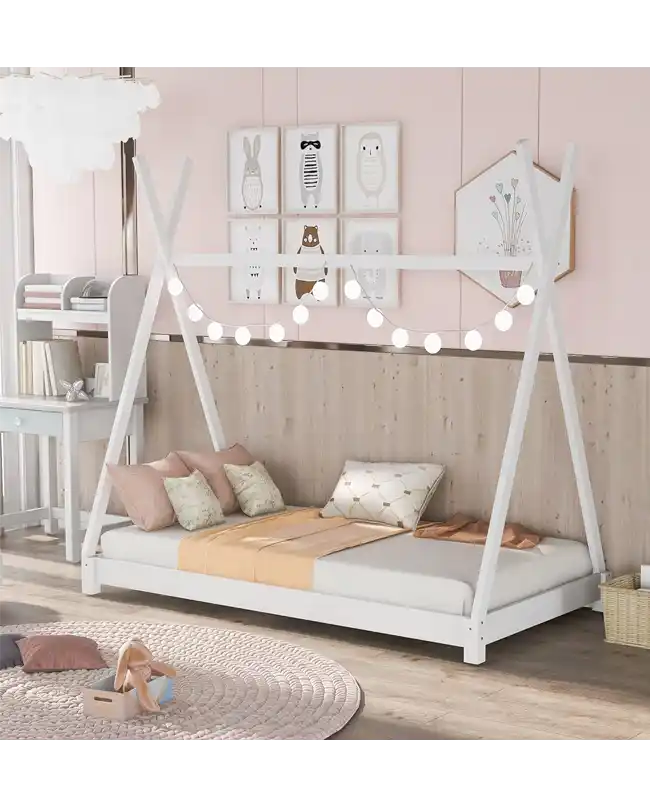 A beautifully designed Montessori floor bed featuring a canopy frame adorned with string lights. The toddler floor bed has a white wooden frame with a low profile, perfect for encouraging independence. The bed is set in a charming, pastel-themed room with cozy pillows and decorative artwork, creating an inviting and playful space for children.