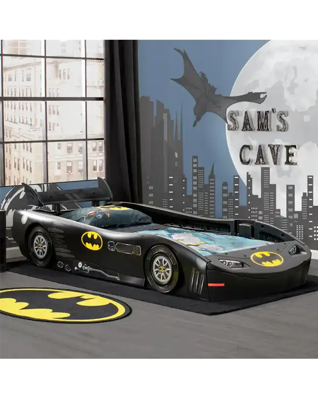 A dynamic DC Comics Batman Batmobile-themed toddler floor bed designed to resemble the iconic Batmobile. The bed features a sleek black frame with Batman logos and realistic car details, creating an exciting and adventurous sleep environment for young superhero fans. The low profile of the bed encourages independence, allowing children to easily get in and out of bed. This Montessori-style bed transforms any child's room into a Gotham City adventure.