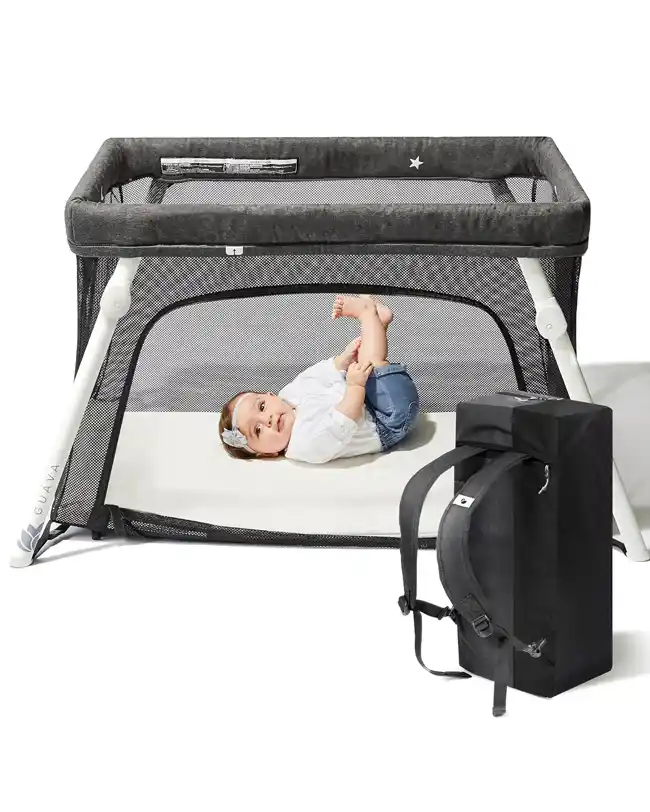 Guava Travel Crib with a baby lying inside and the compact backpack for easy transport, a must-have infant travel essential for comfortable and safe sleeping on the go.