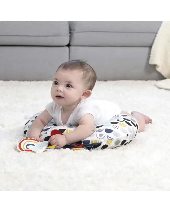 A baby enjoying tummy time on a Boppy Tummy Time Pillow, an ideal tummy time toy for newborn development.