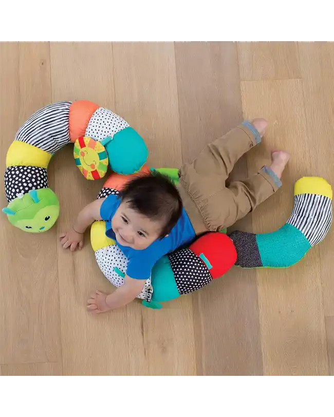 An infant enjoying tummy time with Infantino Go gaga! Prop-A-Pillar, an engaging tummy time support and toy.