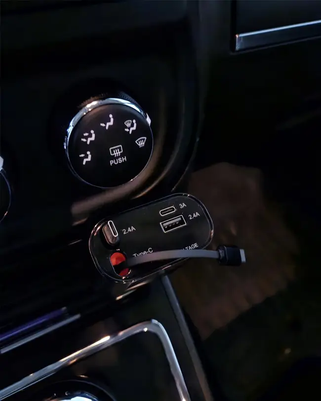 A retractable car charger plugged into a car’s charging port, preventing cord clutter and aiding car organization.