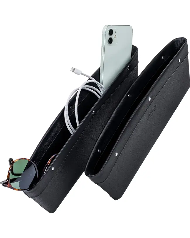 A black car seat gap organizer holding a phone, charging cable, and sunglasses for efficient car organization.