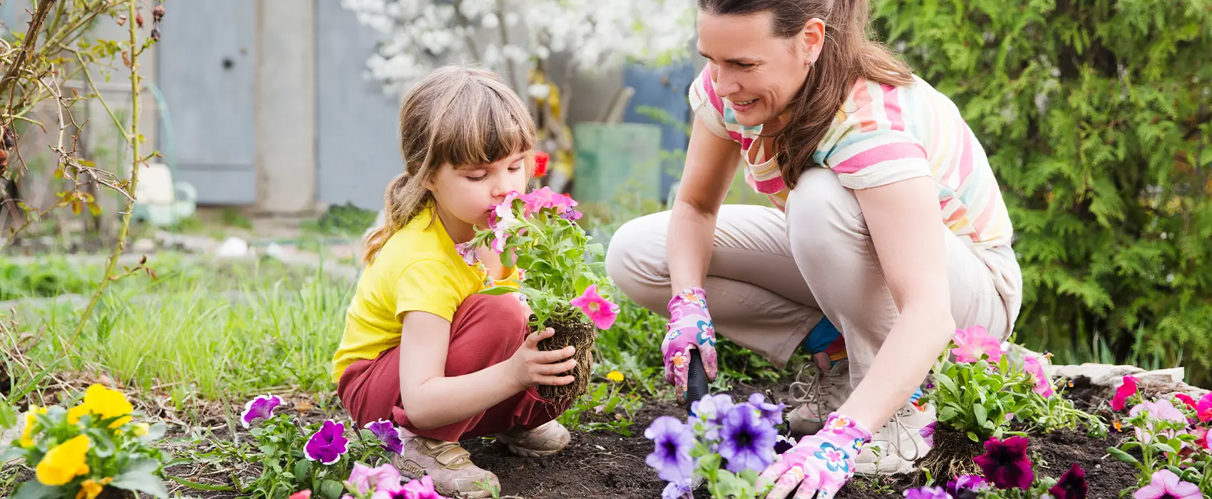 A stay-at-home mom and her child gardening together, illustrating a rewarding and creative hobby for stay-at-home moms. Perfect activity to relax and bond with children.