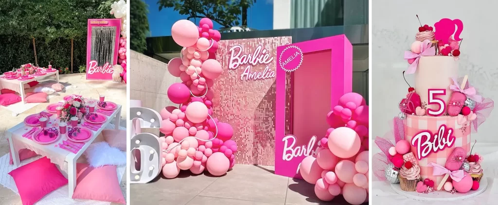 A vibrant Barbie-themed birthday party set-up featuring a pink picnic table decorated with pink plates and flowers, a photo booth with a Barbie box and balloon arch, and a layered birthday cake with pink decorations.