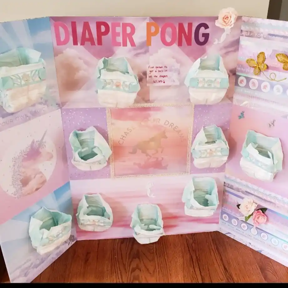 A vibrant unicorn-themed diaper pong board featuring pastel colors and whimsical designs for an exciting baby shower game.