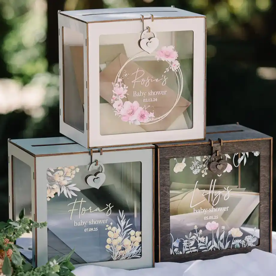 Elegant glass diaper raffle boxes with floral decorations, designed for stylish baby shower games.