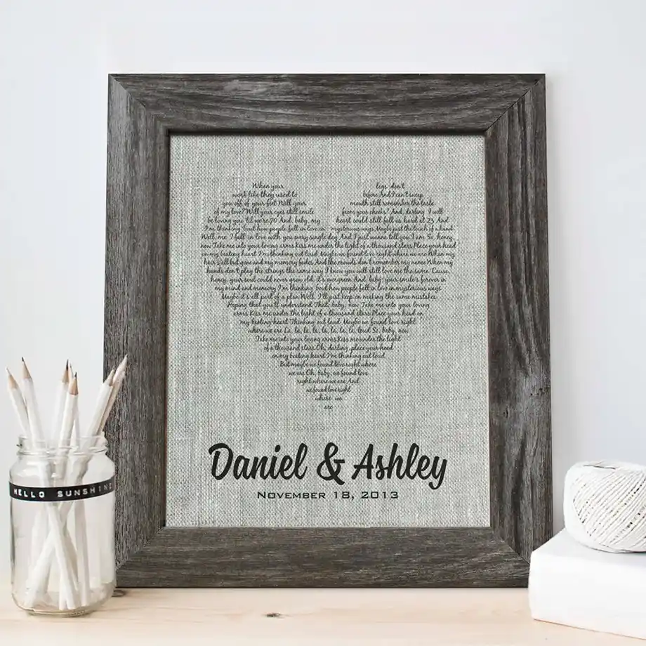 Framed linen art featuring a heart-shaped design made of song lyrics, a meaningful 12-Year Anniversary Gift.